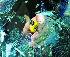 RESQME - Car escape tool smashing a car window