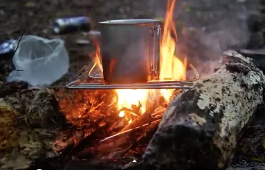45_Survival_SHTF_Tips__Tent_pegs_across_2_logs_for_a_makeshift_grill